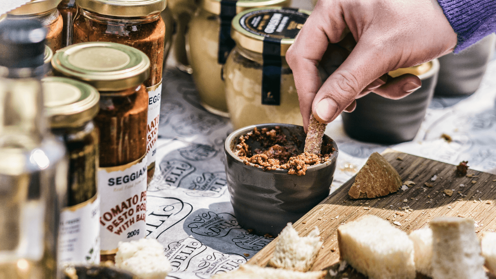 Person trying a locally-produced condiment